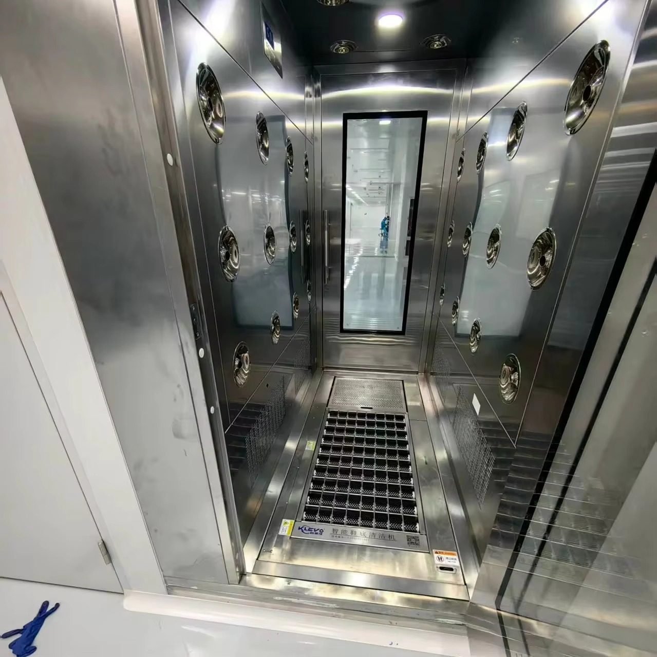 Shoe sole cleaner integrated inside a cleanroom air shower